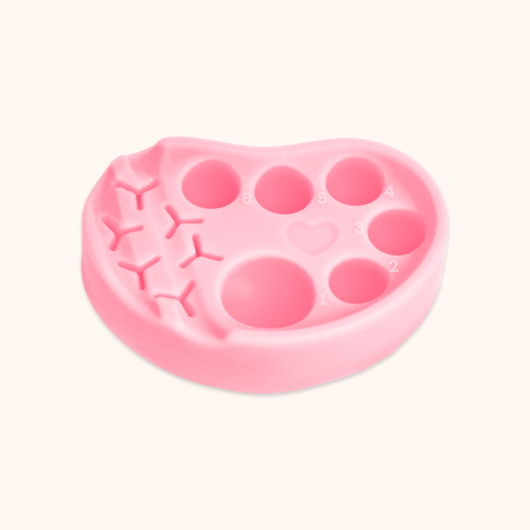 Reusable silicone lash lift palette with 6 glue wells and tool holders. Organizes perm lotion, fixer, glue and tools, ideal for professional lash perm and tint services.